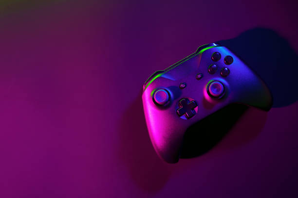 istock Gaming joystick on black background in neon light 1823988318