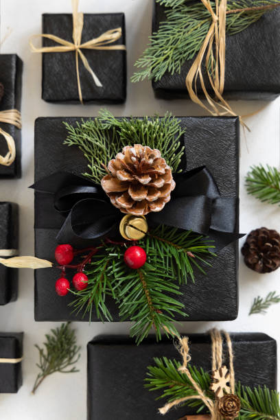 istock Black gift boxes, Christmas decor and green fir branches top view 1823989914