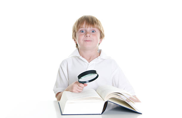 istock Cute Little Boy with Funny Face and a Big Book 182398992