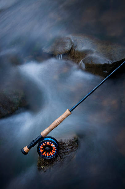 Flyrod in icy creek stock photo
