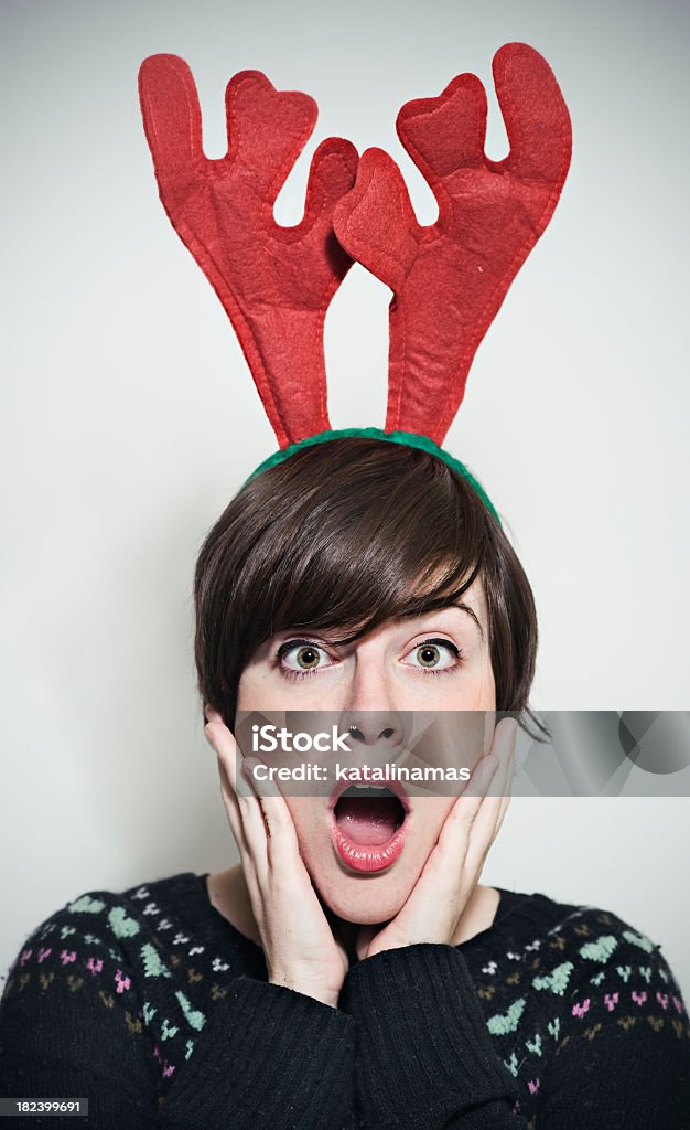 surprised girl with funny reindeer ears Young girl with funny reindeer ears looking very surprised at the camera. Reindeer Stock Photo