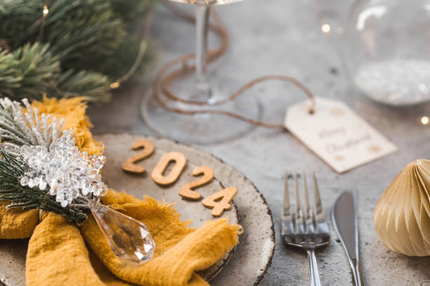 istock Table setting. Stylish plates, napkin, glass, champagne, Christmas tree branches and Christmas decorations on a gray background. The concept of merry Christmas and New Year 2024. 1824004202