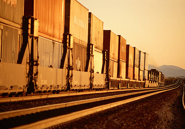 Long Freight Train with containers Freight Train with large containers going thru California desert.See more in this Lightbox: railroad car photos stock pictures, royalty-free photos & images