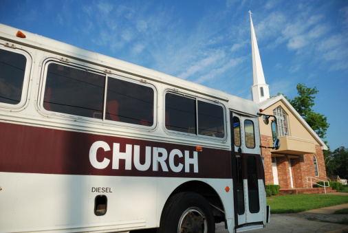 Church bus with sign and church with copy space