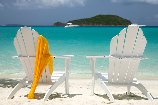 pair of adirondack chairs overlooking a tropical beach in Virgin Islands