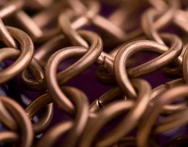 CLose shot of copper chain mail links.