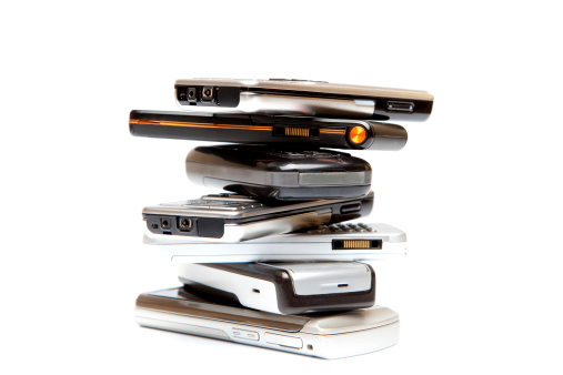 Stack of mobile phones on isolated white background