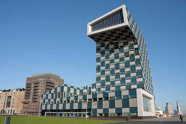 Scheepvaartcollege building Rotterdam "Rotterdam college of navigation and nautical shipping / ocean transport. Modern architectual or modern office building with checkered facade pattern in the Rotterdam Lloyd quarter, The Netherlands.Other famous landmarks in the background." walking point of view stock pictures, royalty-free photos & images