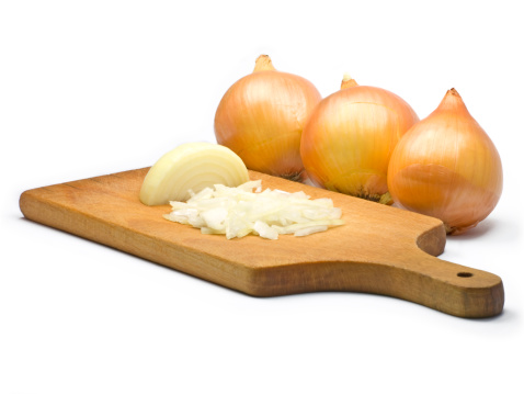 Three onions and chopping board isolated on the white background.