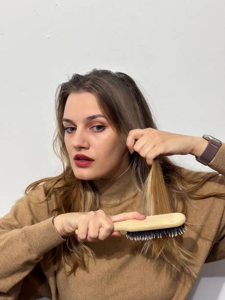 istock Female brushing her long hair with a brush 1824047078