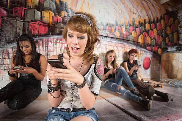 Happy young woman texting with cell phone