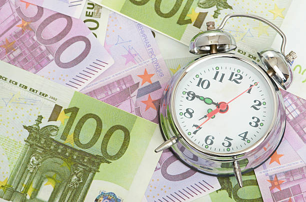 istock Alarm clock for euro banknotes 182405636