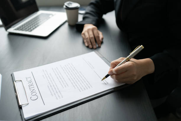 istock Businesswoman signing a document for approve with partner in a folder 1824057390