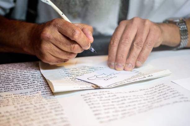 istock Man sitting at a desk and writing with a feather quill 1824061641