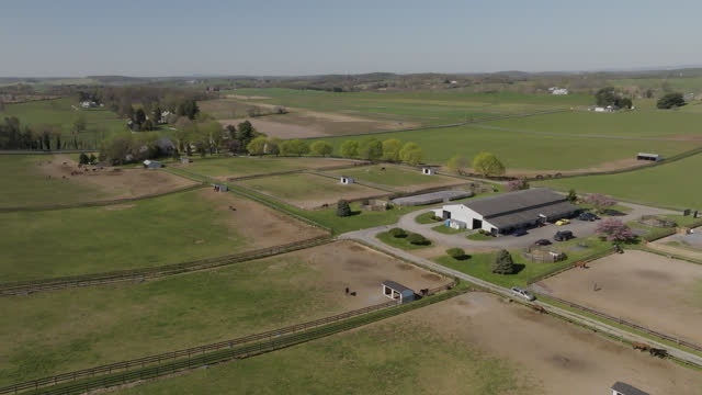 High Angle Establishing Drone Push-In Shot at a Horse Ranch in the Springtime