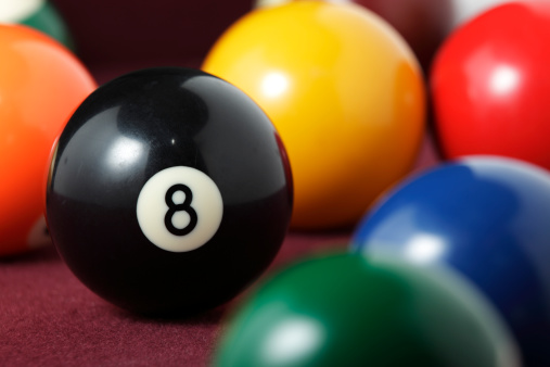 Close up of pool balls with shallow depth of field. Focus on the eight ball.