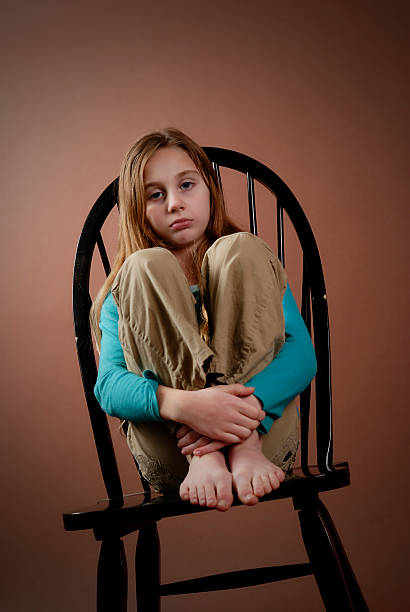 Sad Girl On Chair stock photo