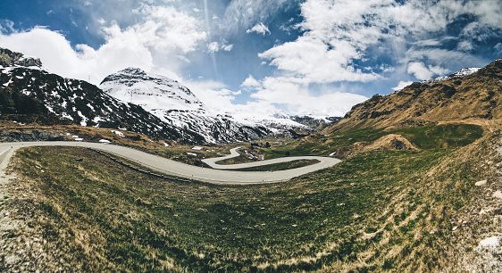 Asphalt road and beautiful mountain scenery under the blue sky