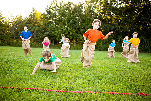 istock Happy Children Having a Fun Potato Sack Race Outside 182408256