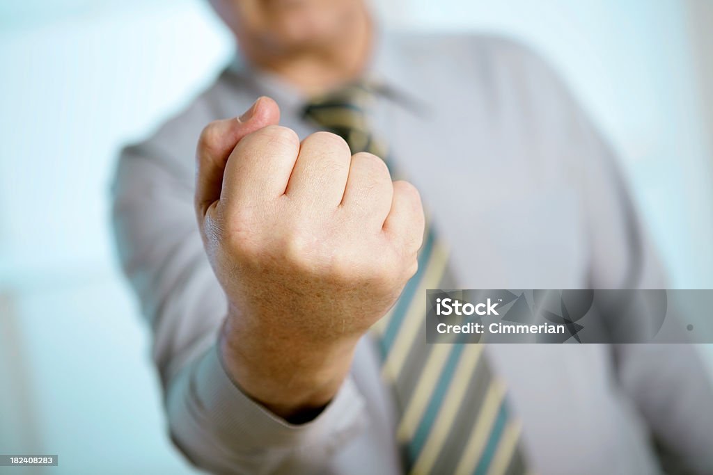 Clenched Fist Businessman showing his clenched fist. Adult Stock Photo