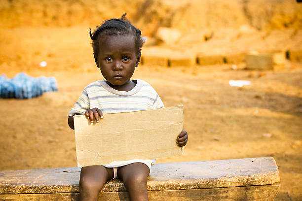 istock African girl holding a blank sign 182408333