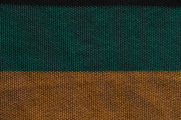 Texture of smooth knitted sweater with pattern. Top view, close-up. Handmade knitting wool or cotton fabric texture. Background of knitting patterns front and back stitch.
