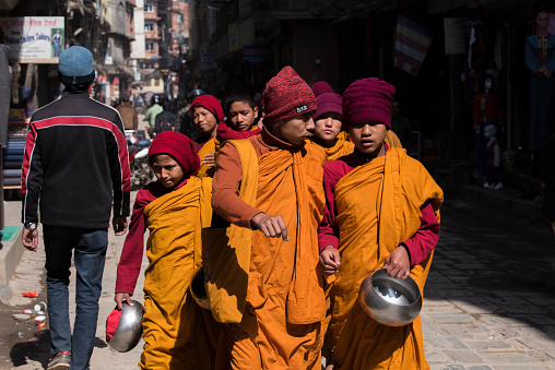 Kathmandu, Nepal- April 20,2019 : Buddhist monks walk the streets of Kathmandu, the capital of Nepal.