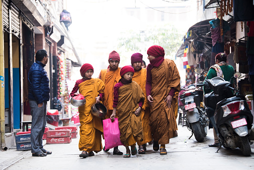 Kathmandu, Nepal- April 20,2019 : Buddhist monks walk the streets of Kathmandu, the capital of Nepal.