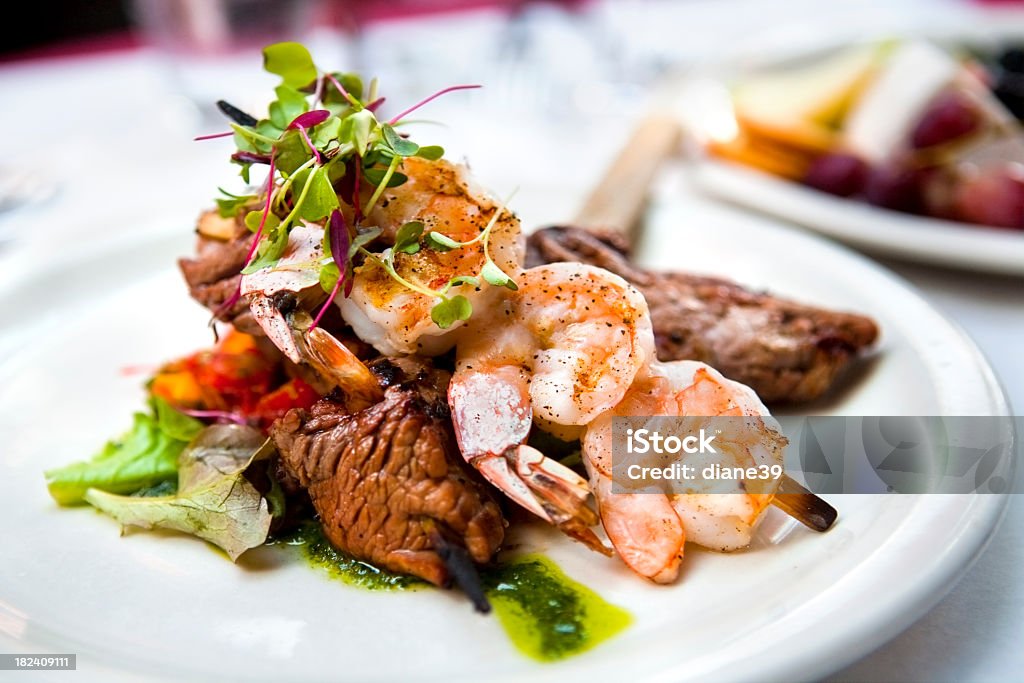 Shrimp and beef skewers A elegantly presented plate of shrimp and beef skewers Gourmet Stock Photo