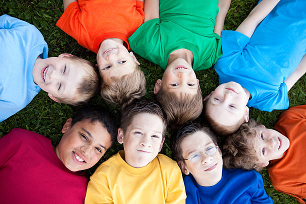 istock Happy Young Boys Lying in a Circle Outside 182409216