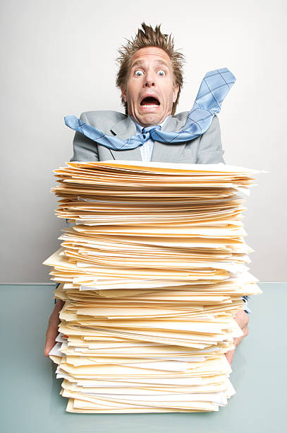 istock Shocked Businessman Office Worker Recoils from Files Inbox 182409425