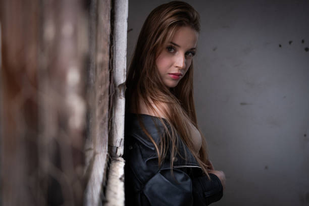 Beautiful young woman posing with leather jacket.