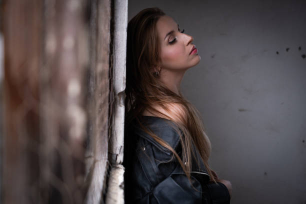 Beautiful young woman posing with leather jacket.