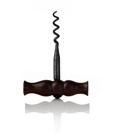 A vintage corkscrew shot on white with a relfection.