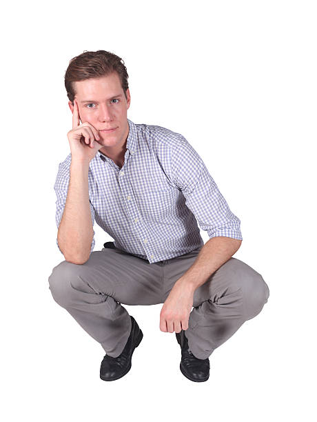 istock Isolated young businessman squatting down 182411787
