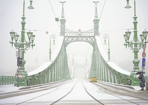 Budapest, Hungary - November 30, 2023: Famous Liberty bridge during snowy winter day.