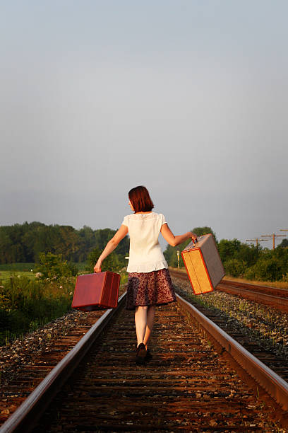 istock Woman walking on a railroad track 182412143