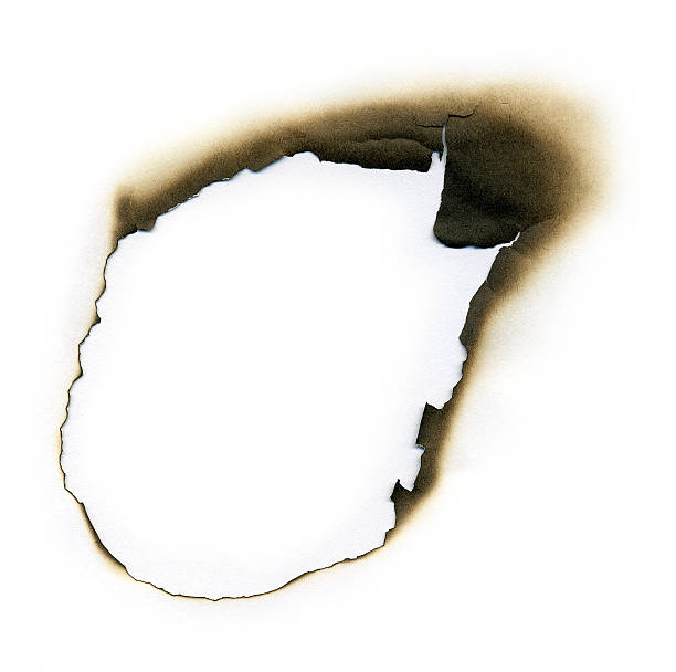 istock White paper with fire damaged burned hole border 182412184