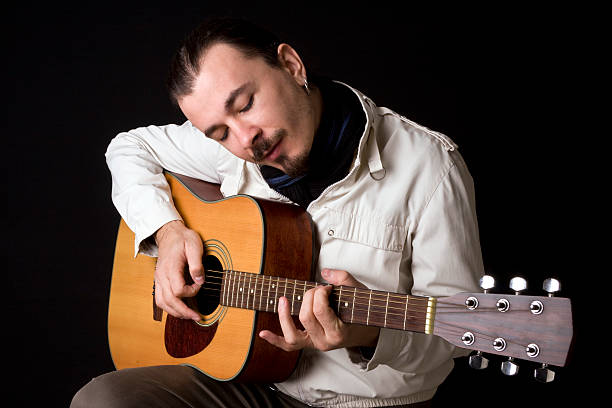 istock Young musician playing guitar 182412304