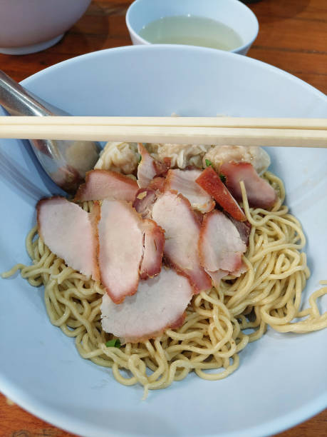 istock Egg noodle with grilled red pork, Restaurant in Bangkok, Thailand. 1824128563