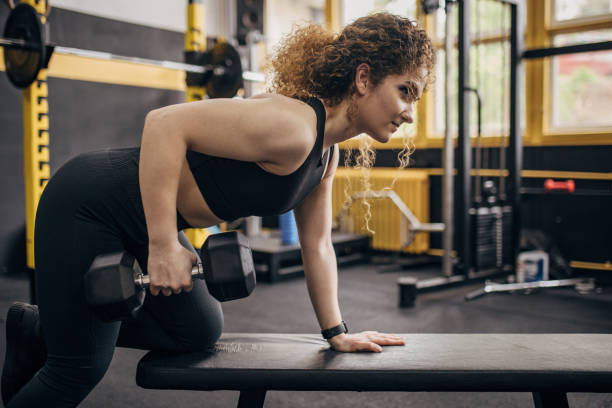 istock Woman exercising with dumbbell 1824129095