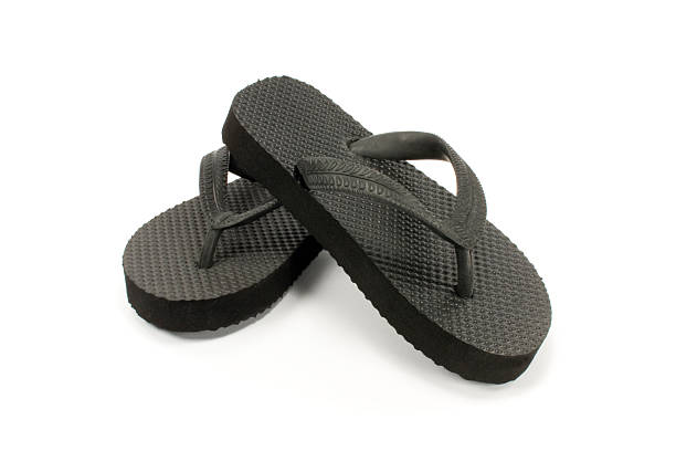 black thongs black thongs or  flip flops or sandals. Isolated. flip flop sandal beach isolated stock pictures, royalty-free photos & images