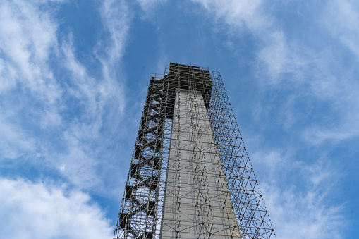 The Bunker hill monument being renovated and covered in scaffolding.