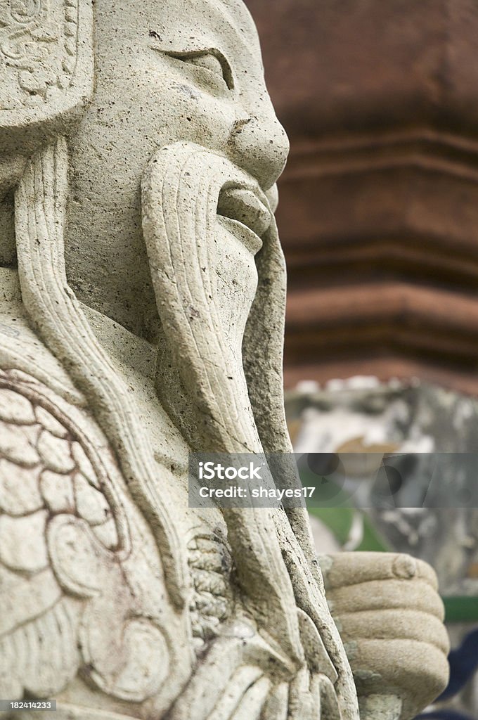 Thailand stone statue "A side view of the head of a Thai stone statue at Wot Arun in Bangkok, Thailand." Asia Stock Photo