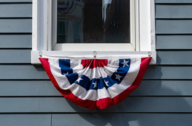 Window with a an American flag patriotic hanging.