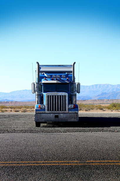 Vertical photo of a blue parked truck with desert background stock photo