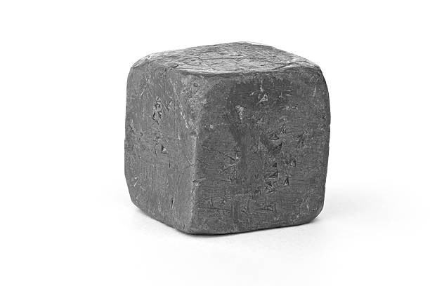 Lead metal cube isolated on white "A cube of pure lead metal against a white background. Lead is very dense, but also very soft, and is easily dented. There are companion images:" lead stock pictures, royalty-free photos & images