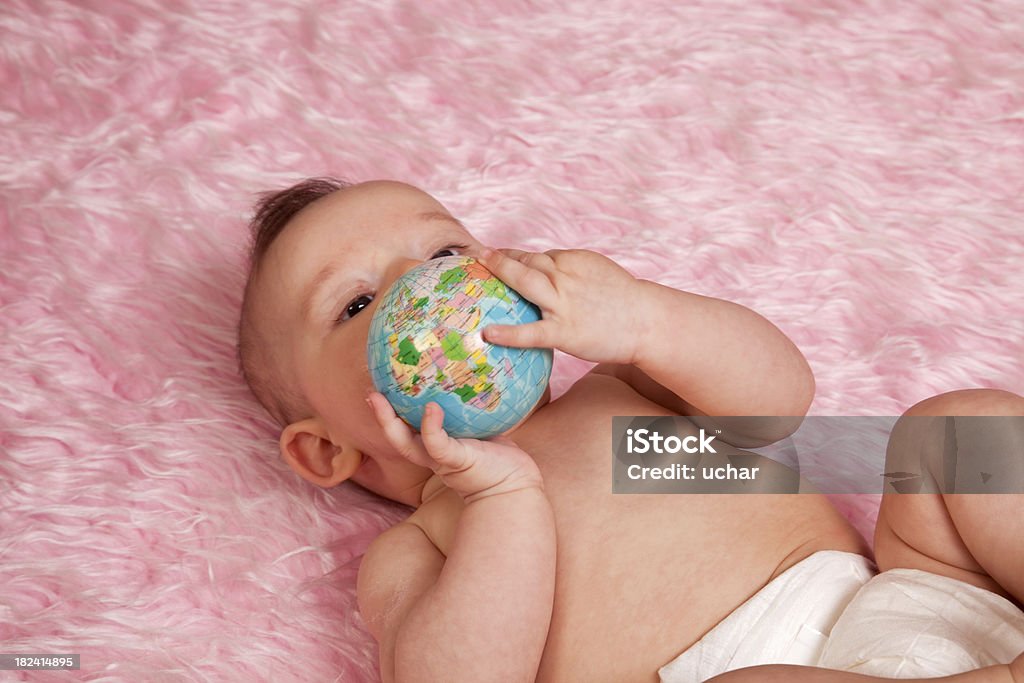 baby in  hands of the world Globe - Navigational Equipment Stock Photo