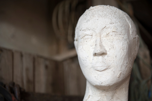 Close up of human head sculptured in paper mache.