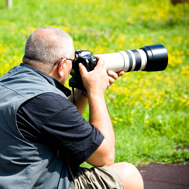 istock Photographer with big telephoto 182415376